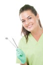 Smiling dentist woman holding dental tools