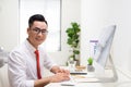 Smiling designer working at his desk in modern office Royalty Free Stock Photo