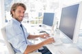 Smiling designer working at his desk