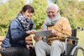 Smiling didabled man and caregiver Royalty Free Stock Photo