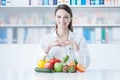 Smiling dietician with healthy vegetables