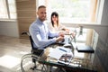 Smiling Disabled Businessman Working On Laptop