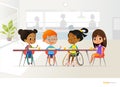 Smiling disabled girl sitting at table in school canteen and talking to her classmates. Children s friendship. Inclusive education Royalty Free Stock Photo