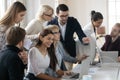 Smiling diverse business people working in small groups on project. Royalty Free Stock Photo