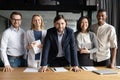 Smiling diverse business people with team leader looking at camera Royalty Free Stock Photo