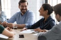 Smiling multiracial colleagues laugh discussing ideas at meeting Royalty Free Stock Photo