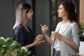 Smiling diverse colleagues chatting during coffee break in office Royalty Free Stock Photo