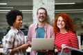 Smiling diverse colleagues gather in boardroom brainstorm discuss financial statistics together Royalty Free Stock Photo