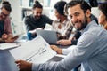 Smiling diverse colleagues gather in boardroom brainstorm discuss financial statistics together Royalty Free Stock Photo