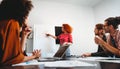 Smiling diverse colleagues gather in boardroom brainstorm discuss financial statistics together Royalty Free Stock Photo