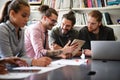 Smiling diverse colleagues gather in boardroom brainstorm discuss financial statistics together Royalty Free Stock Photo