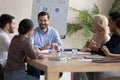 Smiling diverse colleagues laugh brainstorming in office Royalty Free Stock Photo