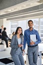 Smiling diverse colleagues standing in office meeting room, vertical portrait. Royalty Free Stock Photo