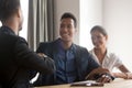 Smiling diverse couple handshaking with financial advisor Royalty Free Stock Photo