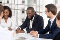 Smiling diverse employees laugh brainstorming at office meeting Royalty Free Stock Photo