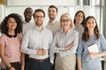 Smiling diverse employees posing for photo in office Royalty Free Stock Photo