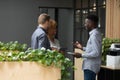 Smiling diverse employees talking, chatting in office during break Royalty Free Stock Photo