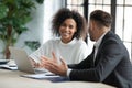 Smiling diverse employees work together on computer in office Royalty Free Stock Photo