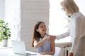 Smiling diverse female colleagues handshake in office