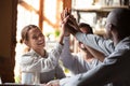 Smiling diverse friends give high five showing unity Royalty Free Stock Photo