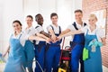 Smiling Diverse Janitors Stacking Hands Royalty Free Stock Photo