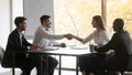 Smiling diverse partners handshake get acquainted at meeting Royalty Free Stock Photo