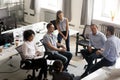 Smiling diversity team of employees listening to business coach Royalty Free Stock Photo