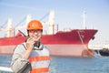 Smiling dock worker holding radio