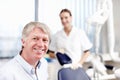 Smiling doctor with assistant. Portrait of handsome dentist smiling with his assistant in office.