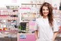 Smiling doctor in front of pharmacy desk