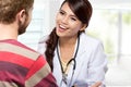 Smiling doctor giving a consultation to a patient in her medical Royalty Free Stock Photo