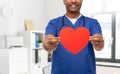 smiling doctor or male nurse with red heart Royalty Free Stock Photo