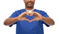 smiling doctor or male nurse with red heart Royalty Free Stock Photo