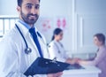 Smiling doctor man standing in front of his team and patient Royalty Free Stock Photo