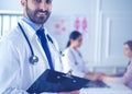 Smiling doctor man standing in front of his team and patient Royalty Free Stock Photo