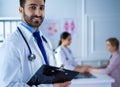 Smiling doctor man standing in front of his team and patient Royalty Free Stock Photo