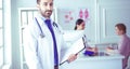 Smiling doctor man standing in front of his team and patient Royalty Free Stock Photo