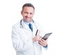 Smiling doctor or medic using credit card and wireless tablet