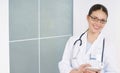 Smiling doctor with medicine equipment working at hospital