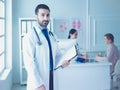 Smiling doctor man standing in front of his team and patient Royalty Free Stock Photo