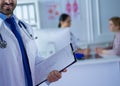 Smiling doctor man standing in front of his team and patient Royalty Free Stock Photo