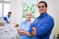 Smiling doctor and nurse standing with arms crossed Royalty Free Stock Photo