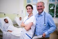 Smiling doctor and nurse standing in ward Royalty Free Stock Photo