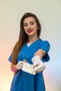 Smiling doctor offering pills in blister. Woman wearing medical uniform and protective gloves Royalty Free Stock Photo