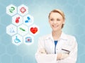 Smiling doctor over medical icons blue background Royalty Free Stock Photo