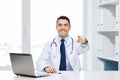 Smiling doctor pointing finger at you in office Royalty Free Stock Photo