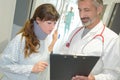 Smiling doctor showing xray to female patient wearing neckbrace