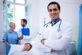 Smiling doctor standing with arms crossed in hospital Royalty Free Stock Photo