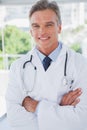 Smiling doctor standing with arms crossed Royalty Free Stock Photo