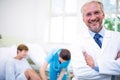 Smiling doctor standing with arms crossed Royalty Free Stock Photo